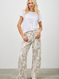 Model wearing High Rise Low Curve Barrel jeans with a white t-shirt and stylish look.