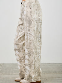 High Rise Low Curve Barrel jeans featuring a printed design and a contemporary silhouette, perfect for a trendy look.