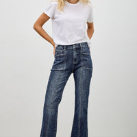 High Rise Boot Cut With Seam Detail, stylish women's jeans with flared hem and seam detailing, model wearing white t-shirt.