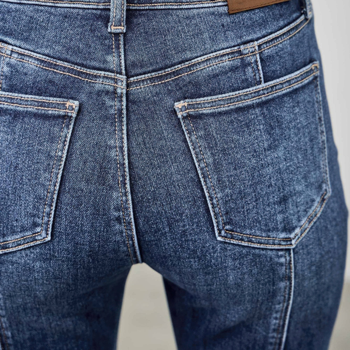 High Rise Boot Cut With Seam Detail back view showcasing the pocket and seam details on stretchy denim jeans.