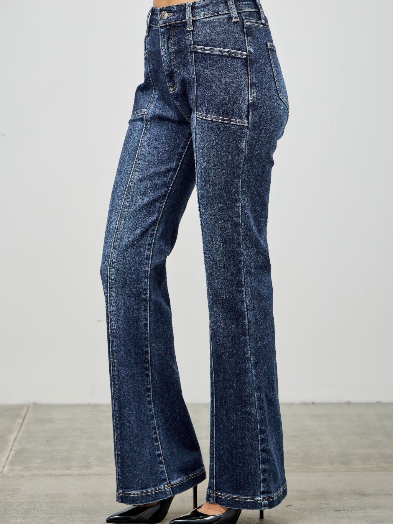 High Rise Boot Cut With Seam Detail displayed in dark denim, featuring a flattering high-rise fit and stylish seam details.