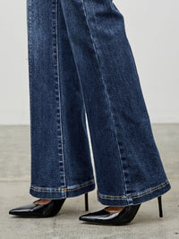 High Rise Boot Cut With Seam Detail showcasing flared hem paired with stylish black heels.