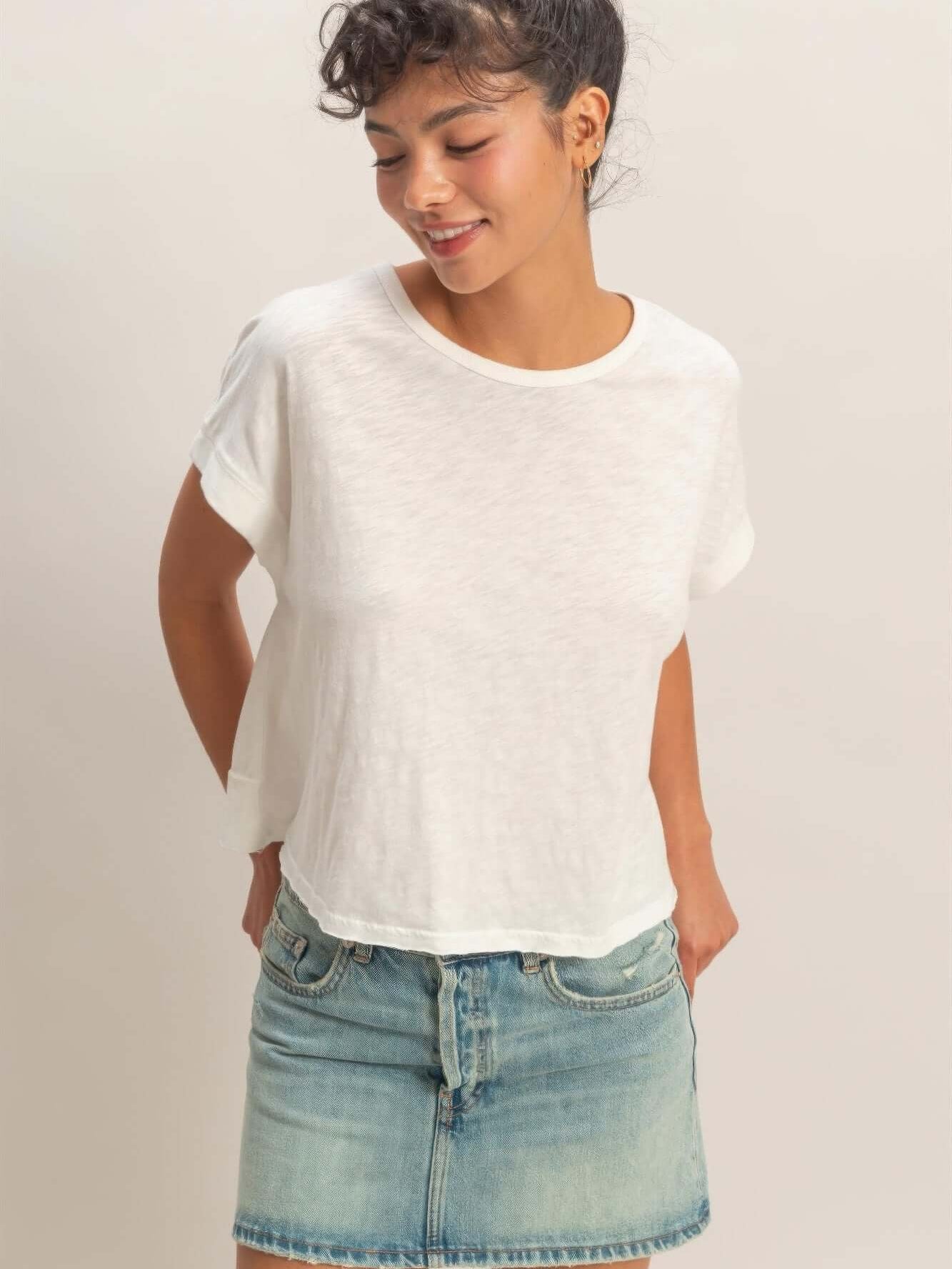 Acid Washed Cross Detail Open Back Top worn with a casual denim skirt, featuring a relaxed fit and soft fabric.
