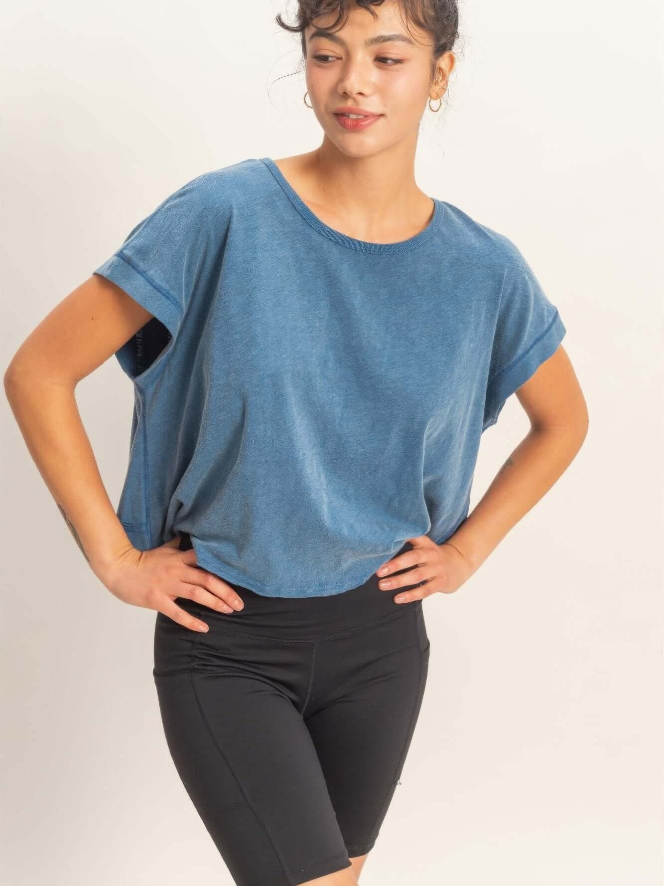 Acid Washed Cross Detail Open Back Top worn with black shorts, showcasing a casual, stylish look.