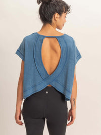 Model showcasing the Acid Washed Cross Detail Open Back Top with a modern silhouette and open back design.