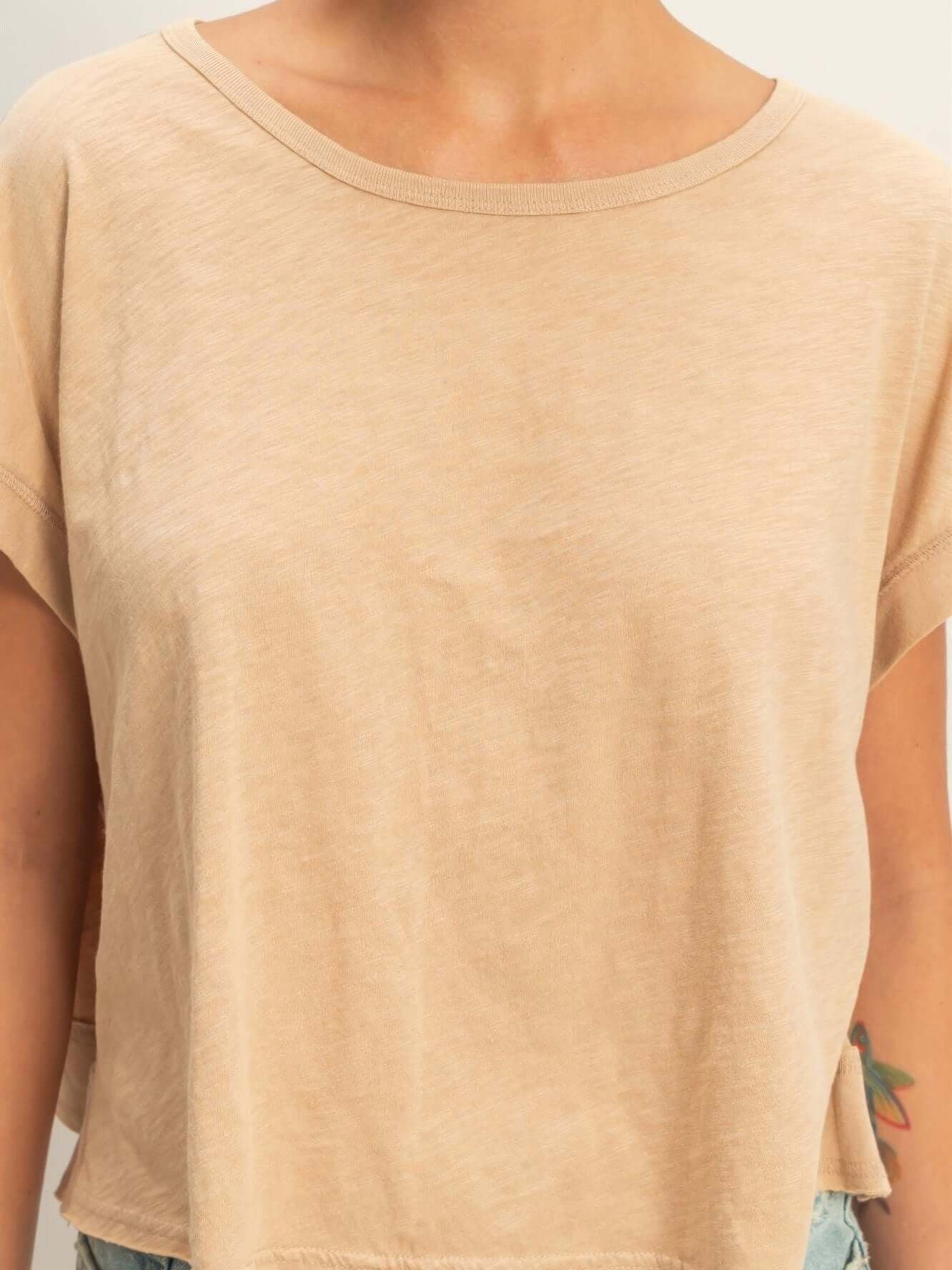 Acid Washed Cross Detail Open Back Top displayed on model with a light beige color and relaxed fit.