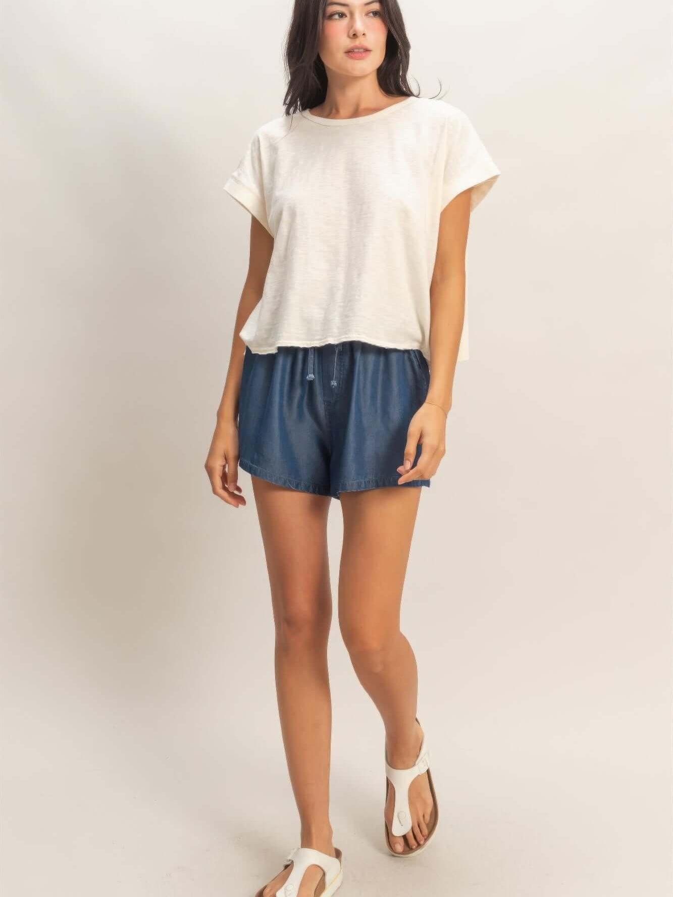 Acid Washed Cross Detail Open Back Top paired with shorts and sandals on model.