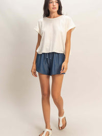 Acid Washed Cross Detail Open Back Top paired with shorts and sandals on model.