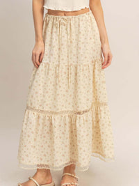 Stylish model wearing a Tiered Lace Trim Skirt with floral patterns and delicate lace details.