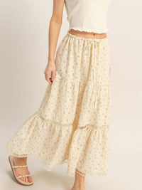 Model wearing a Tiered Lace Trim Skirt with floral detailing and an adjustable drawstring waistband.