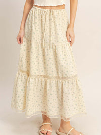 Tiered Lace Trim Skirt featuring a delicate floral print, lightweight fabric, and adjustable drawstring waistband.