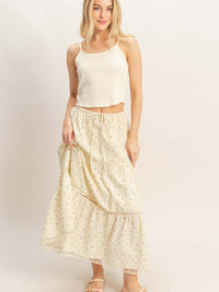 Woman wearing a Tiered Lace Trim Skirt with lace detailing and a drawstring waistband, paired with a crop top.
