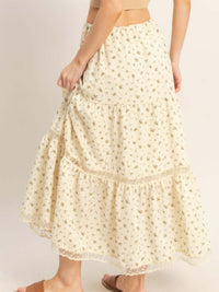 Back view of a woman in a tiered lace trim skirt featuring floral patterns and a comfortable waistband.
