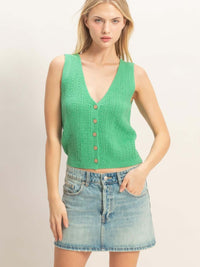 Image of a stylish woman wearing a V-neck Knit Tank Top in green with a button-front design and a denim skirt.