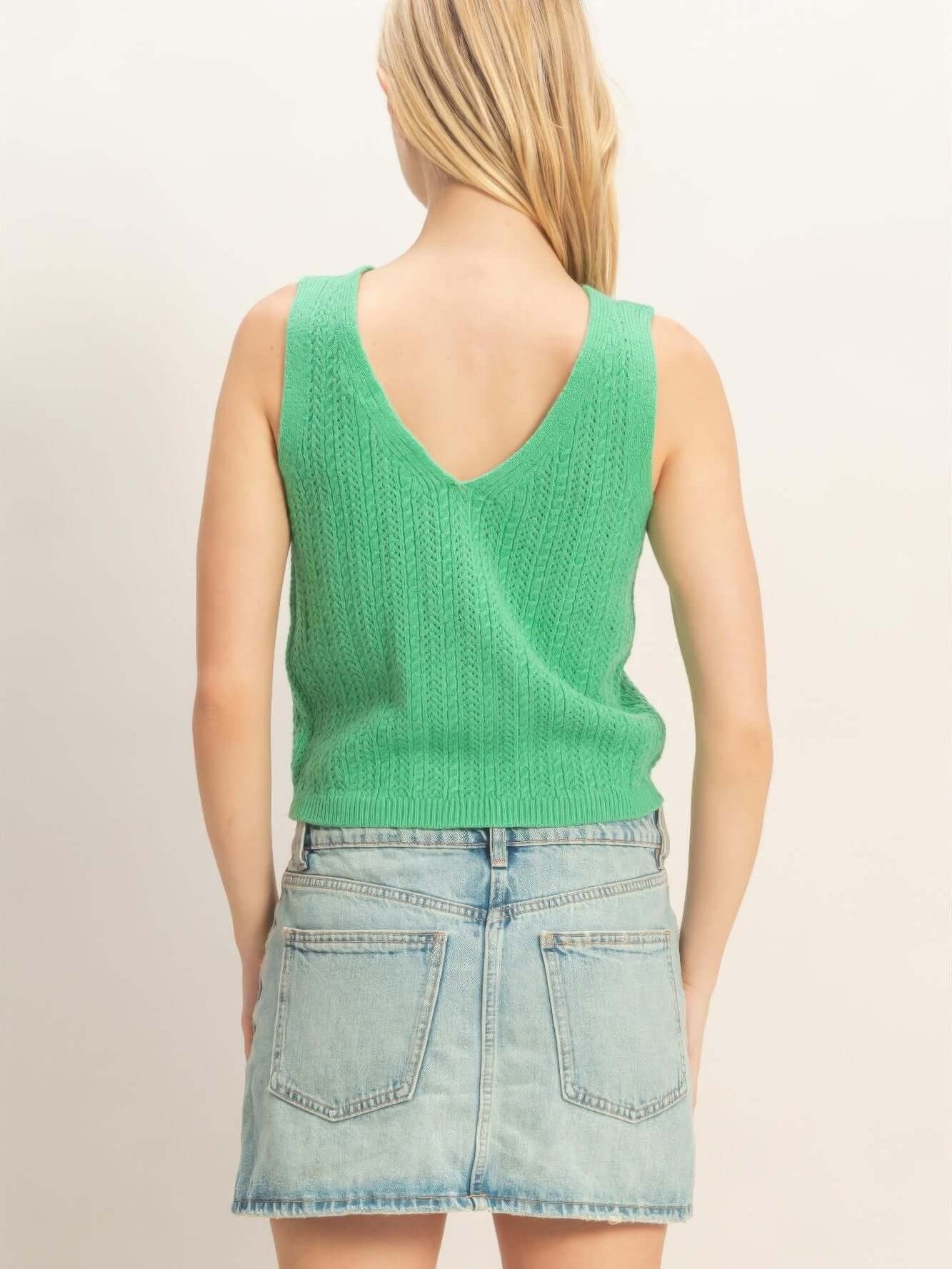 Back view of a woman wearing a V-neck Knit Tank Top in green with a casual denim skirt.