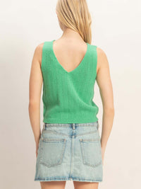 Back view of a woman wearing a V-neck Knit Tank Top in green with a casual denim skirt.