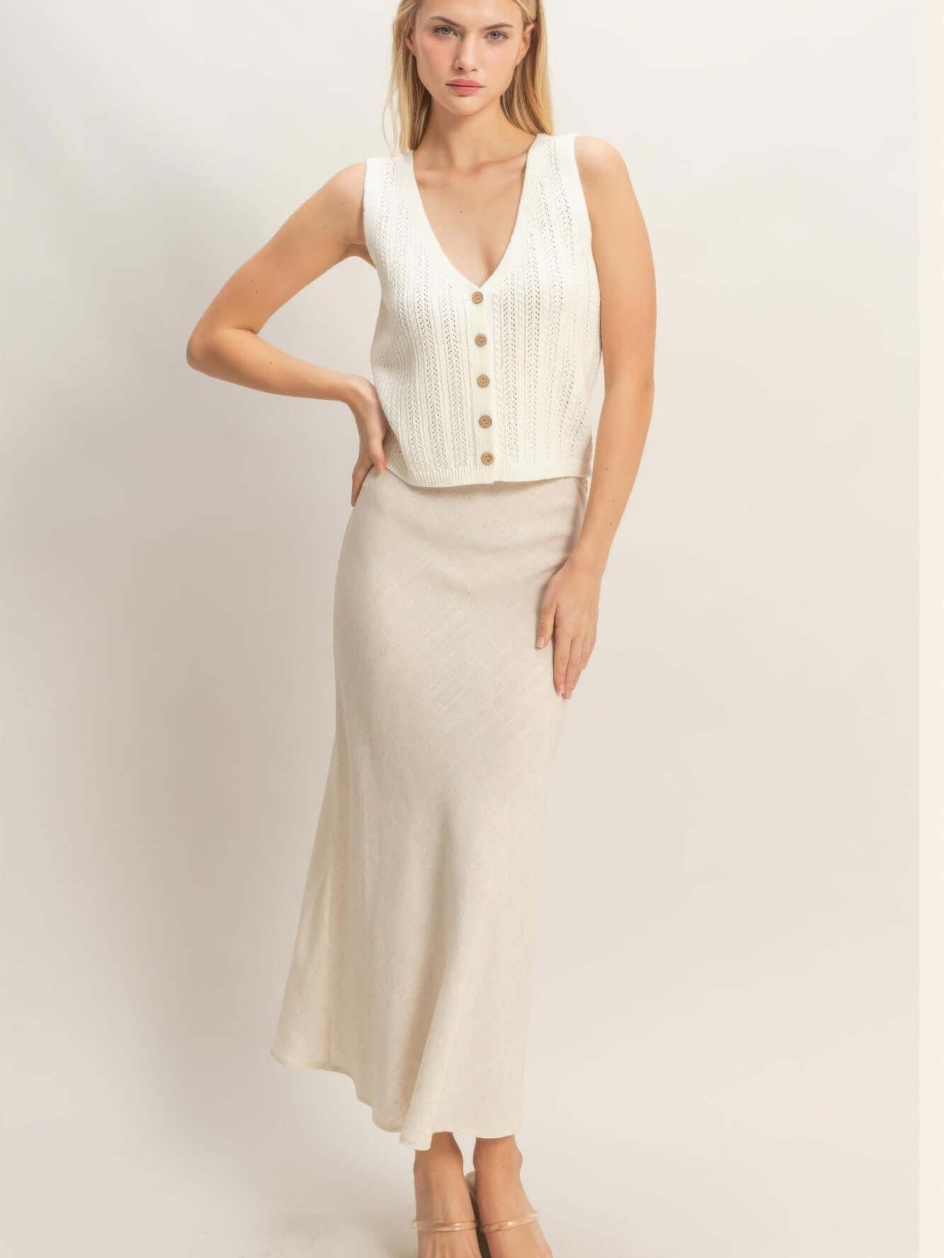 Model wearing a V-neck Knit Tank Top with button-front closure, styled with a long skirt.