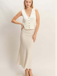 Model wearing a V-neck Knit Tank Top with button-front closure, styled with a long skirt.