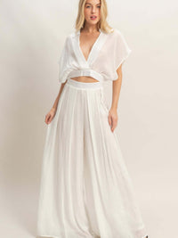 Model wearing Collared Wrap Top & Wide-leg Pants Set in white, showcasing effortless sophistication and stylish comfort.