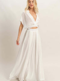 Collared Wrap Top & Wide-leg Pants Set modeled by a woman, showcasing a chic white outfit with a structured collar and flowing pants.