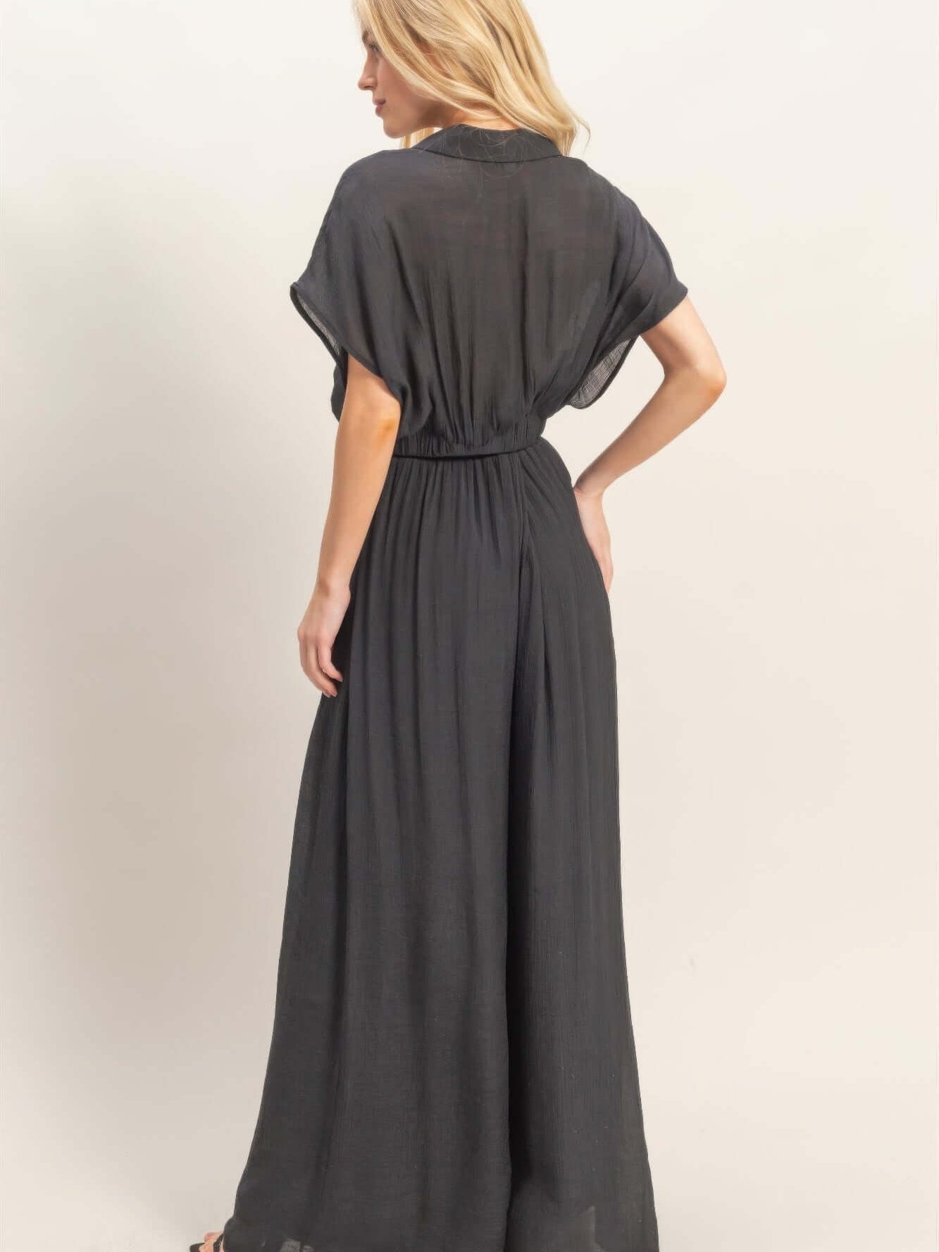 Back view of a model wearing a Collared Wrap Top & Wide-leg Pants Set in black, showcasing graceful drape and style.