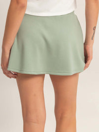 Back view of a model wearing a Wrap Front Elastic Waist Skort in mint green, showcasing its smooth texture and modern design.