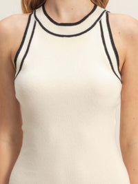 Ribbed Sleeveless Dress featuring a soft white fabric with contrasting black trim on the neckline.