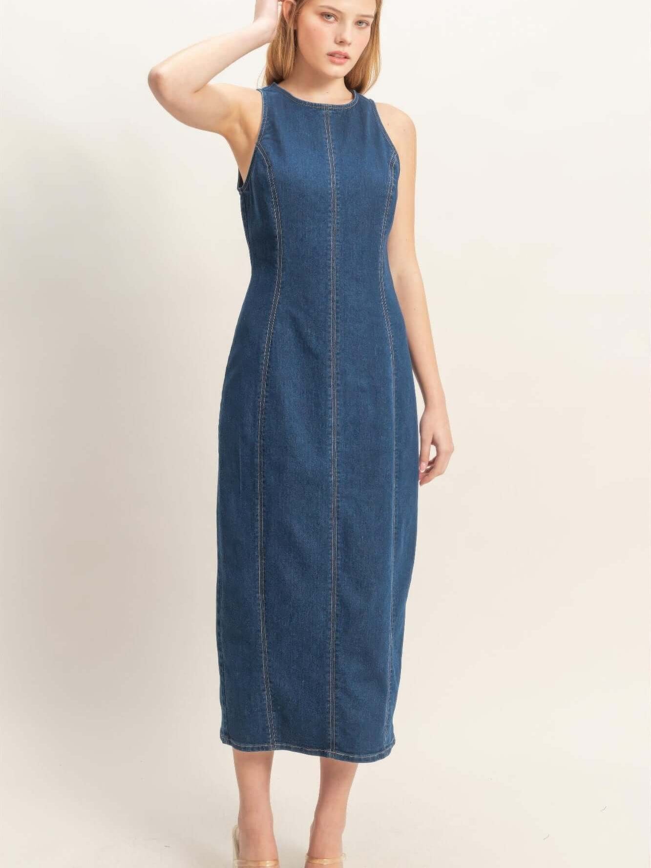 Sleeveless Denim Midi Dress modeled by a woman, showcasing clean lines and a comfortable stretch-blend fabric.