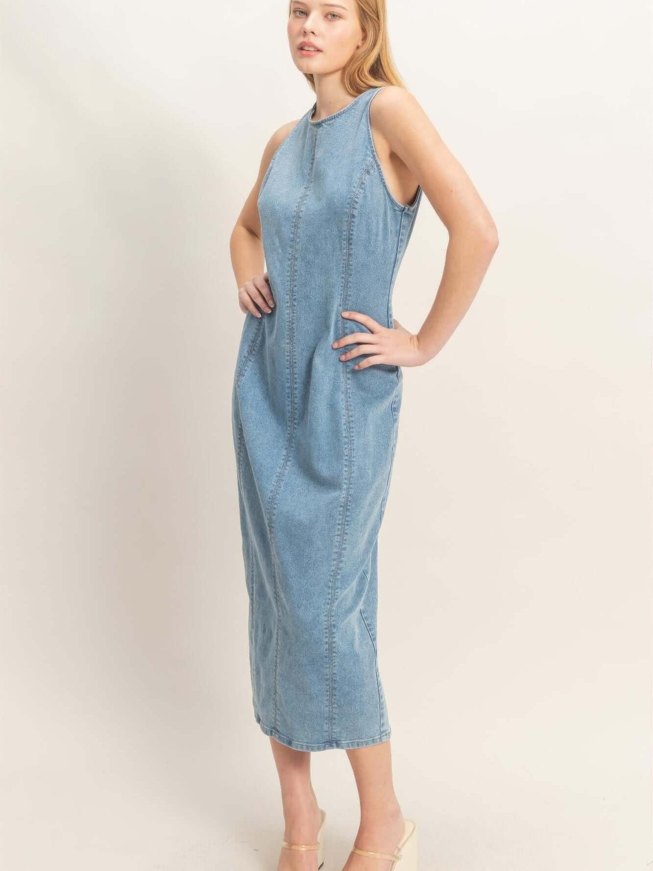 Model wearing a Sleeveless Denim Midi Dress, showcasing its modern design and comfortable fit.