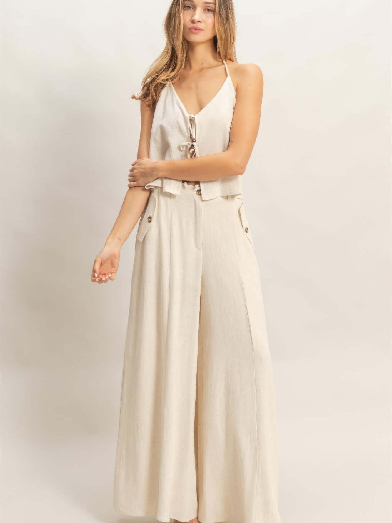 Wide-leg Flap Pocket Pants in light beige with a halter top and flap pockets for a stylish summer look.