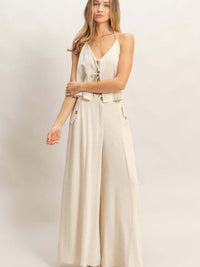 Wide-leg Flap Pocket Pants in light beige with a halter top and flap pockets for a stylish summer look.