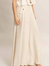 Wide-leg Flap Pocket Pants showcasing a lightweight rayon-linen blend fabric with a flowing silhouette and flap pockets.