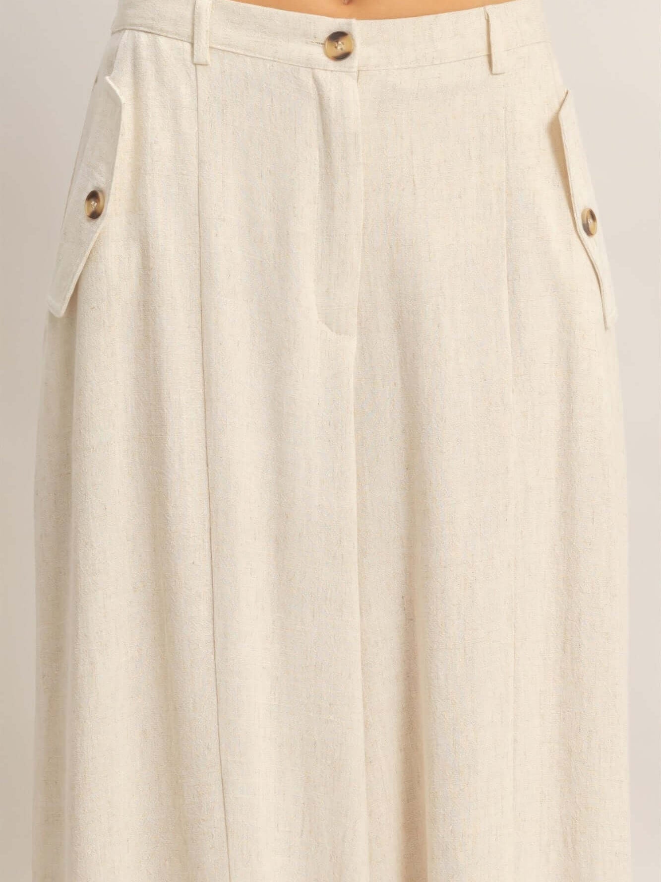 Wide-leg Flap Pocket Pants showcasing flap pockets and button closure detail on a lightweight fabric.