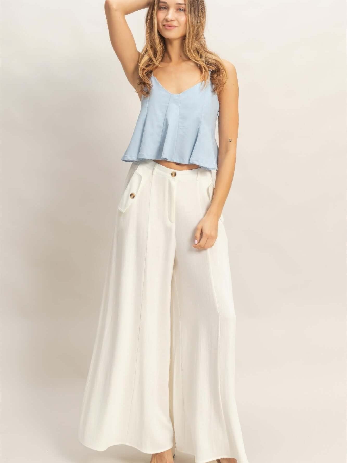 Model showcasing Wide-leg Flap Pocket Pants paired with a casual blue top, highlighting a stylish and comfortable outfit.