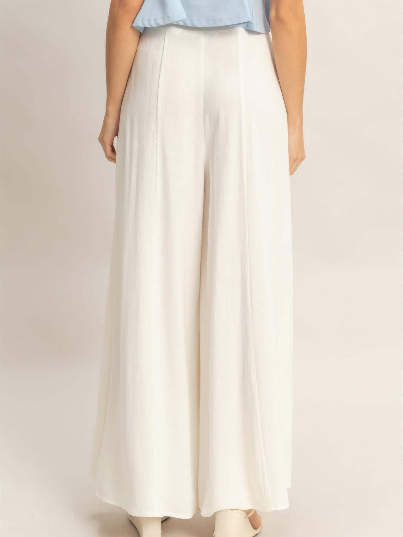 Wide-leg Flap Pocket Pants featuring a back view showcasing the flowing silhouette and elegant design.