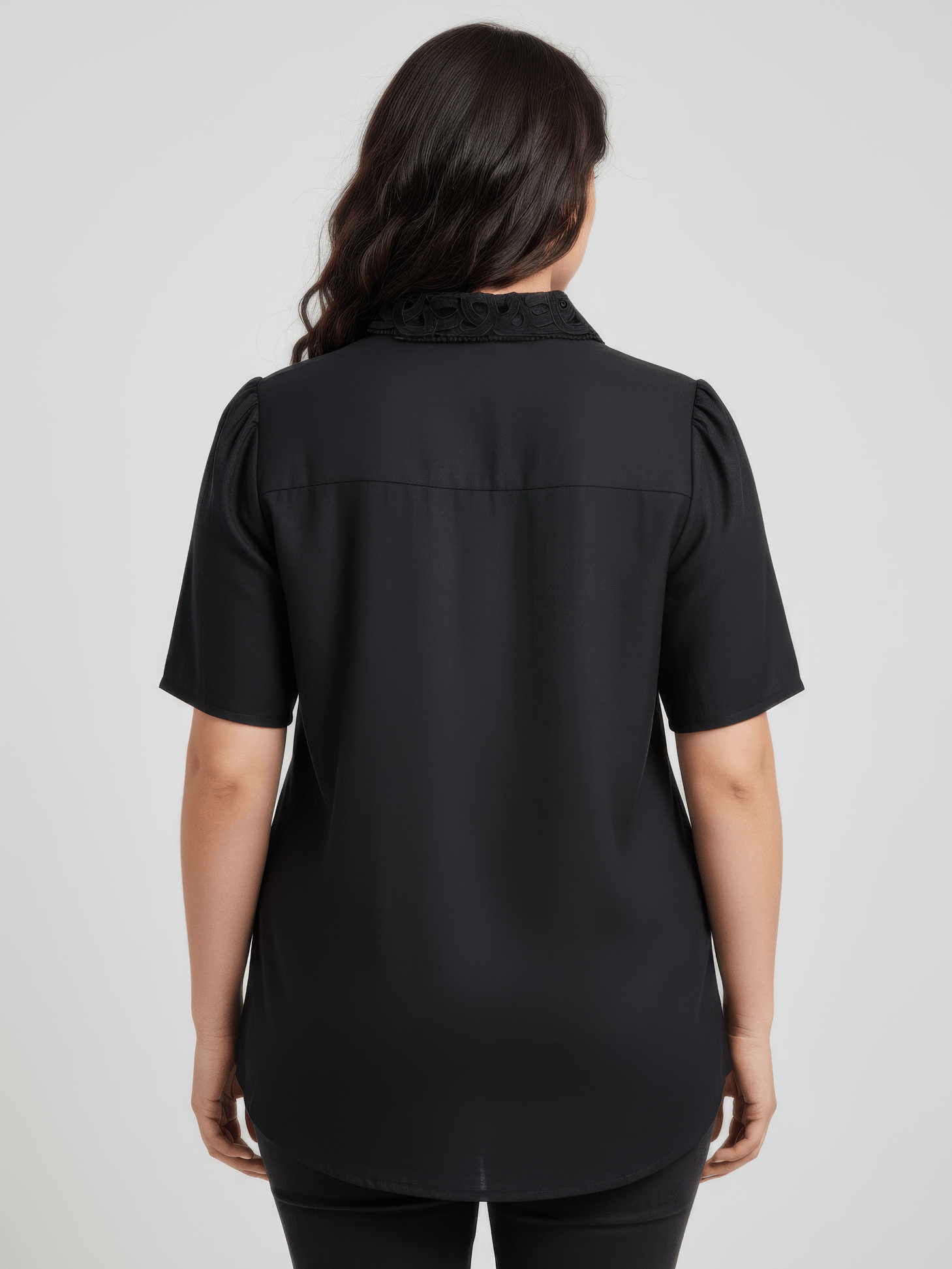 Back view of The Inez Lace Panel Collared Blouse showcasing the lace collar detail and short sleeves in black.