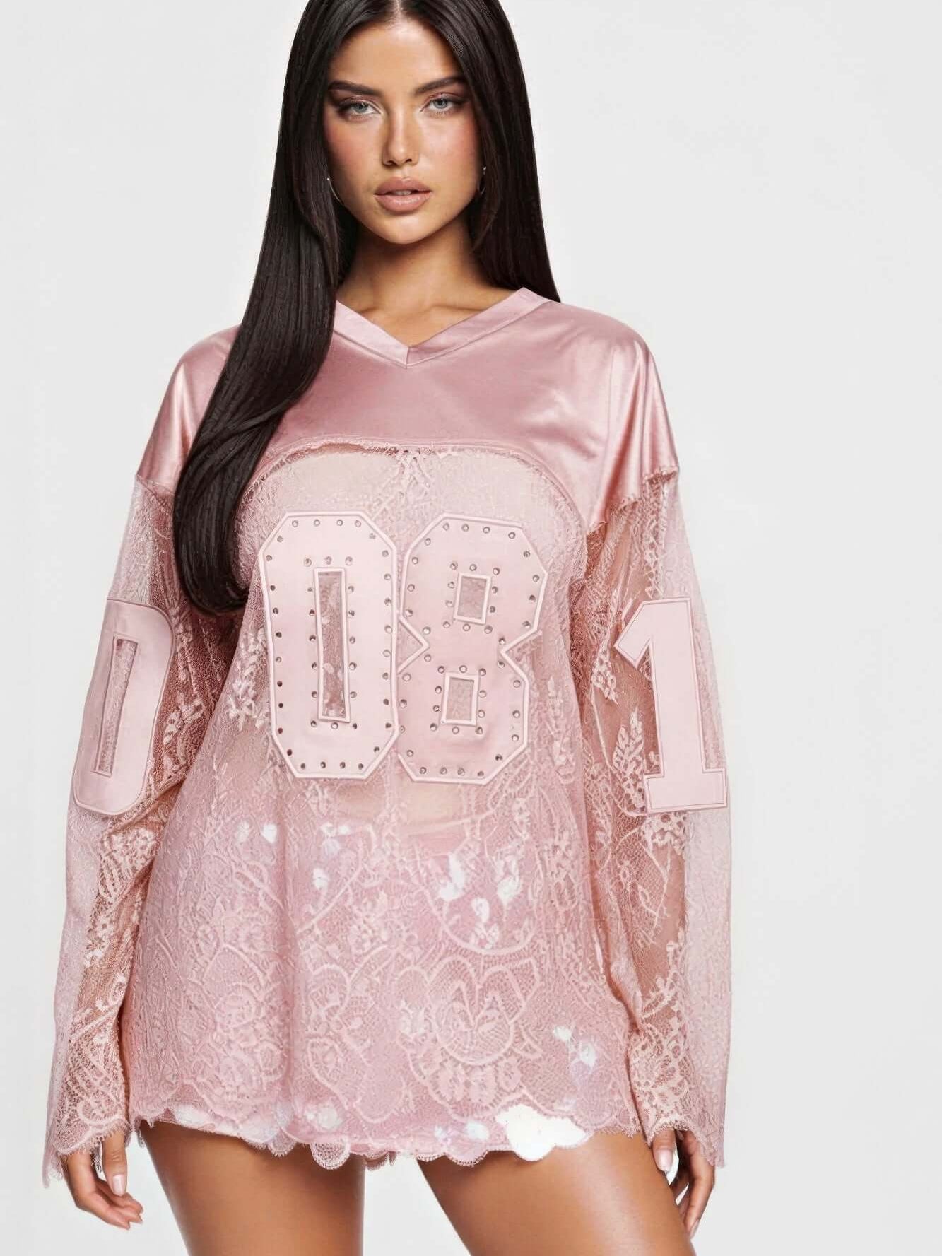 08 Long Sleeve Jersey Top with rhinestone graphic and lace detailing in a pink color for a bold athletic look.