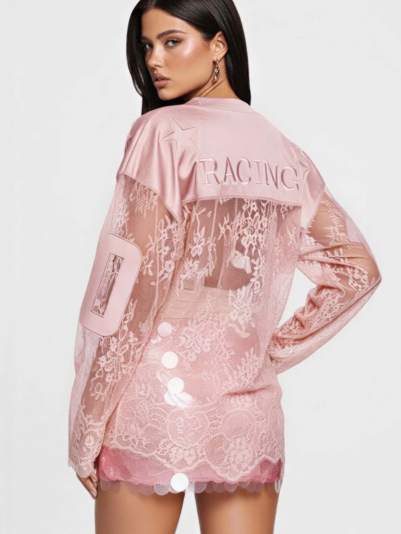 Stylish model wearing a pink lace long sleeve top with 'RACING' print and button details on the back.