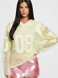08 Long Sleeve Jersey Top featuring a V neckline, rhinestone accents, and lace detailing for a sporty style.