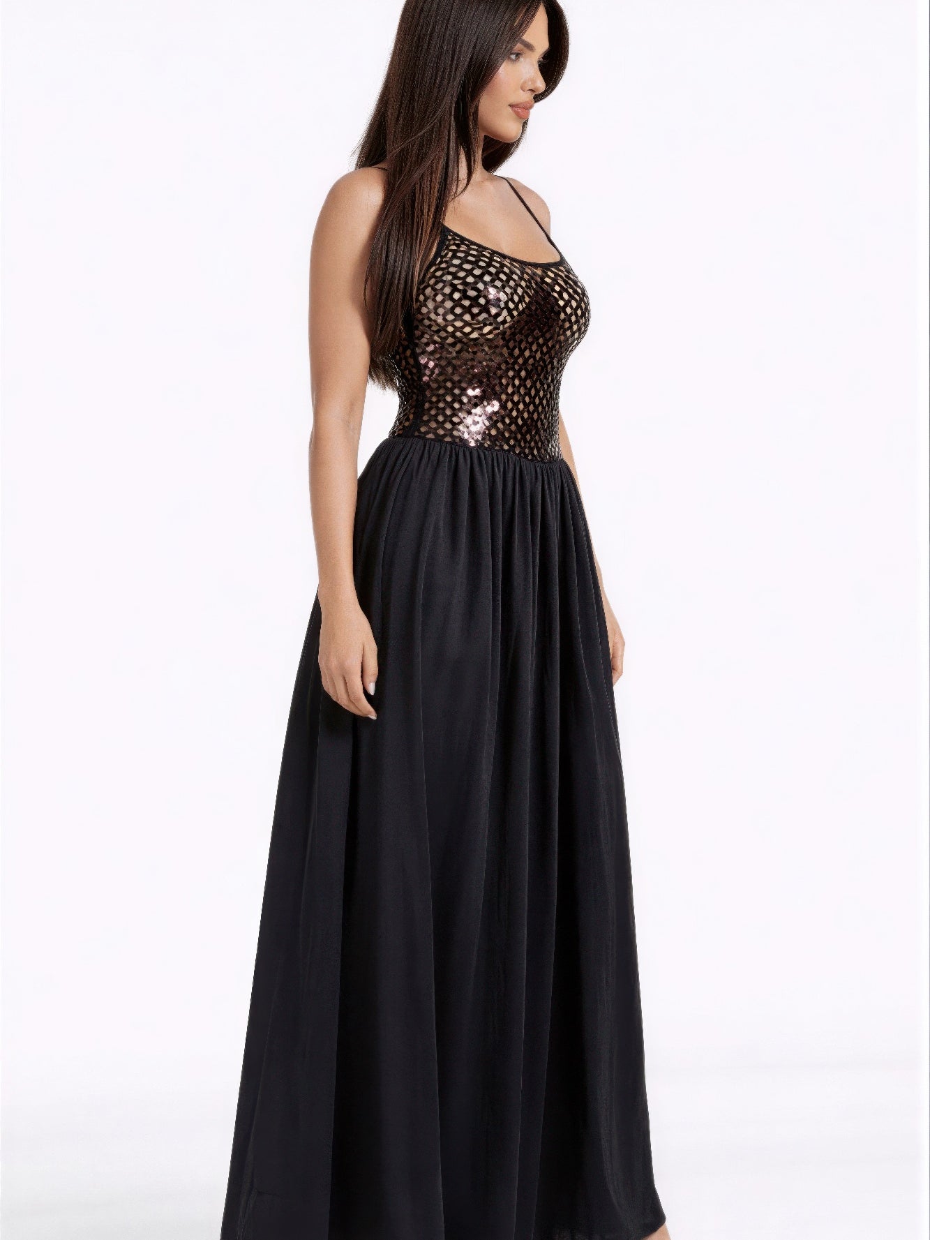 Model showcases a Netted Sequin Maxi Dress featuring a shimmering bodice and flowing maxi skirt.