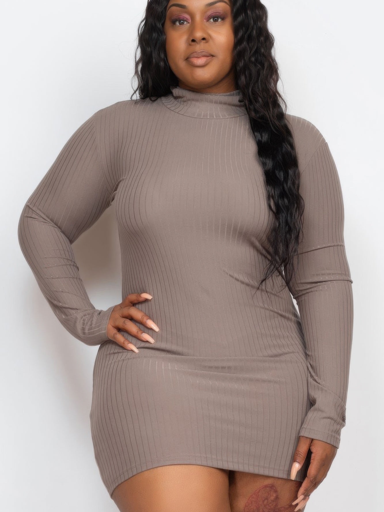 Plus size model wearing a ribbed long sleeve mock neck mini bodycon dress in taupe, showcasing a flattering fit and stylish design.