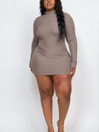 Plus size model wearing a ribbed long sleeve mock neck mini bodycon dress in taupe, showcasing a flattering silhouette.