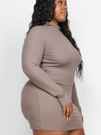 Plus size model wearing a ribbed long sleeve mock neck mini bodycon dress in taupe, showcasing a flattering silhouette.