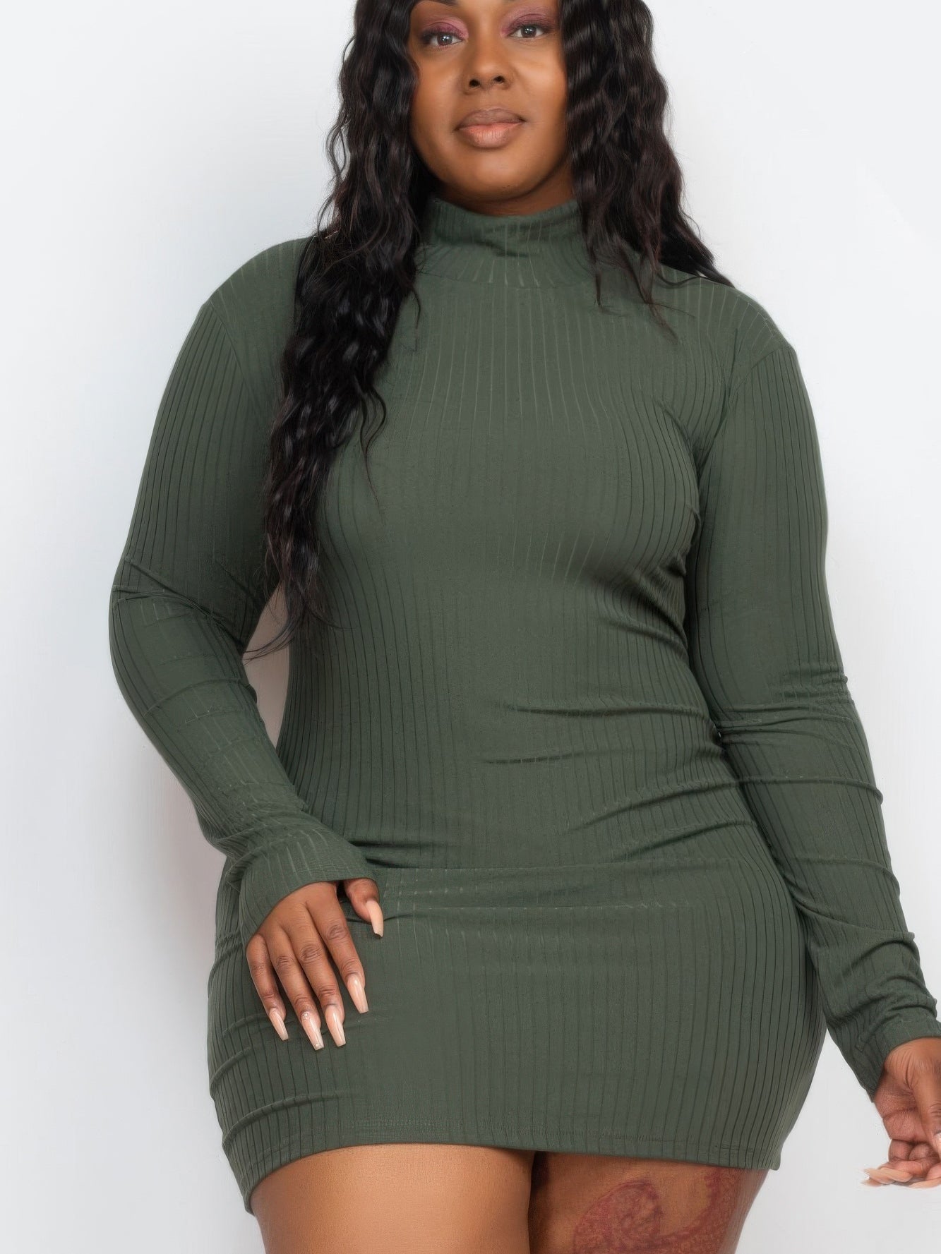 Plus size woman wearing a ribbed long sleeve mock neck mini bodycon dress in olive green, highlighting a flattering silhouette.