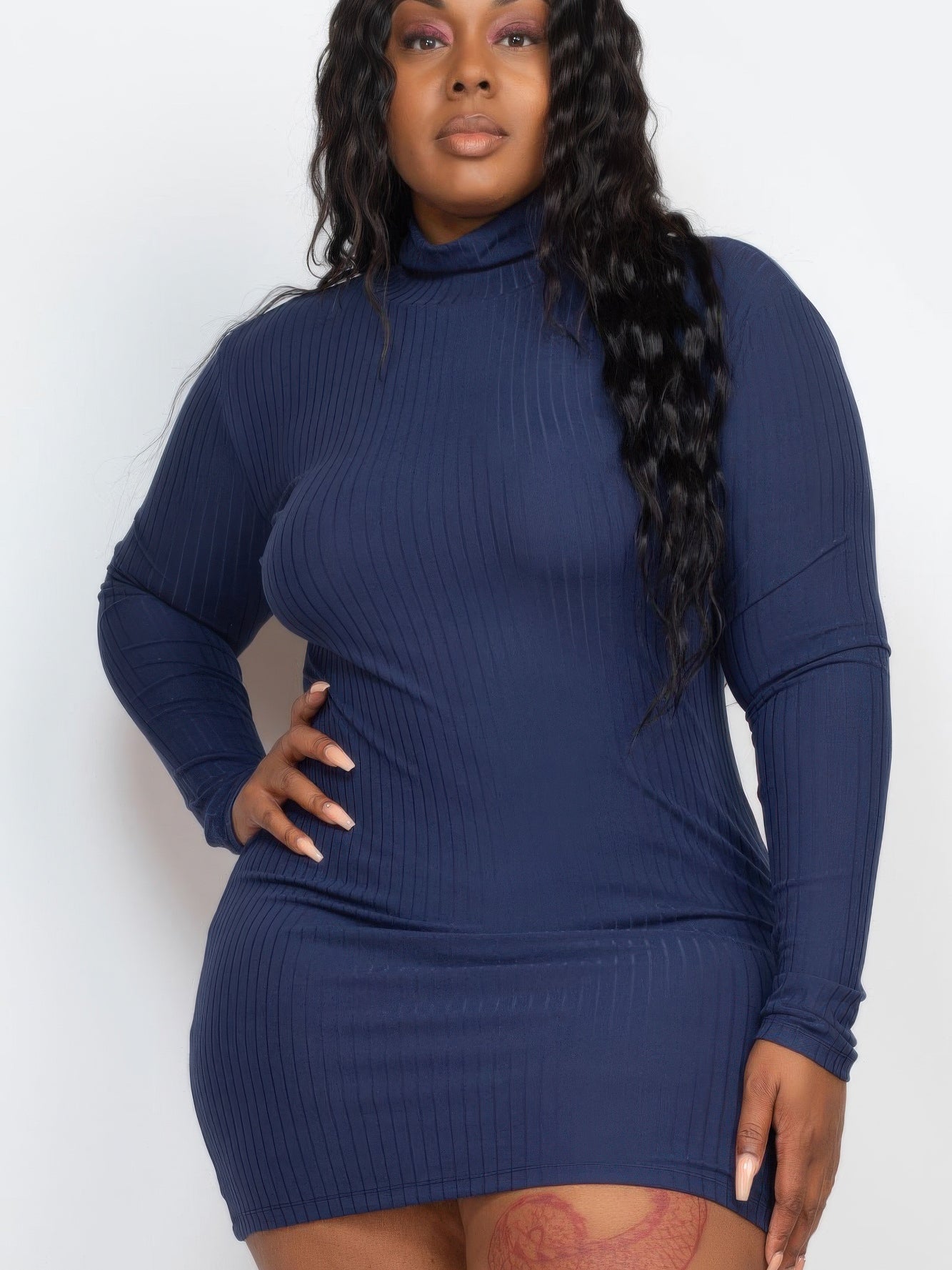 Plus size model wearing a ribbed long sleeve mock neck mini bodycon dress in navy, showcasing a flattering silhouette.