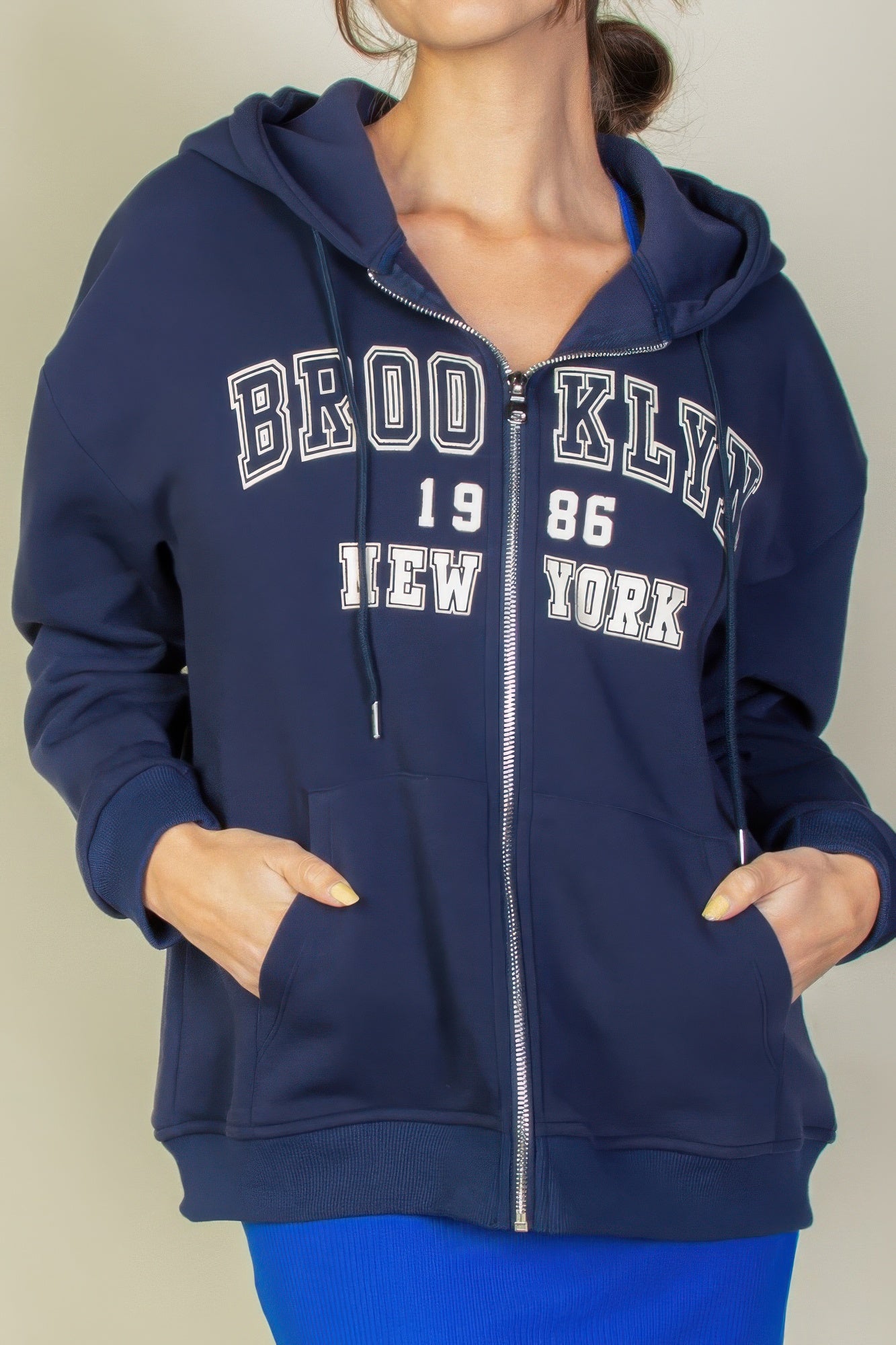 Graphic drop shoulder zip-up hoodie with "Brooklyn 1986 New York" logo, styled for a casual look and functional comfort.