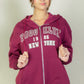 Model wearing a burgundy Graphic Drop Shoulder Zipper Up Hoodie with Brooklyn logo, perfect for casual styles.