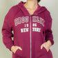 Model wearing a burgundy Graphic Drop Shoulder Zipper Up Hoodie featuring Brooklyn logo, perfect for casual style.