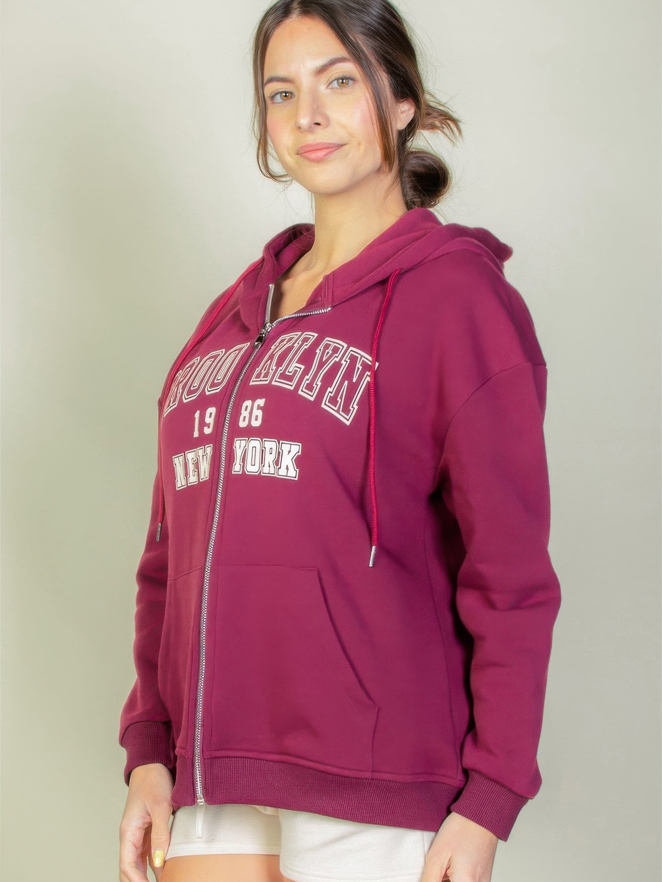 Model wearing a maroon Graphic Drop Shoulder Zipper Up Hoodie featuring a Brooklyn logo, perfect for casual style.