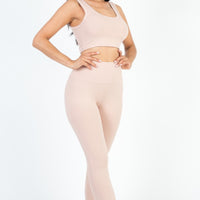 Model showcasing ribbed crop top and leggings set in soft pink, highlighting comfort and style for active days.